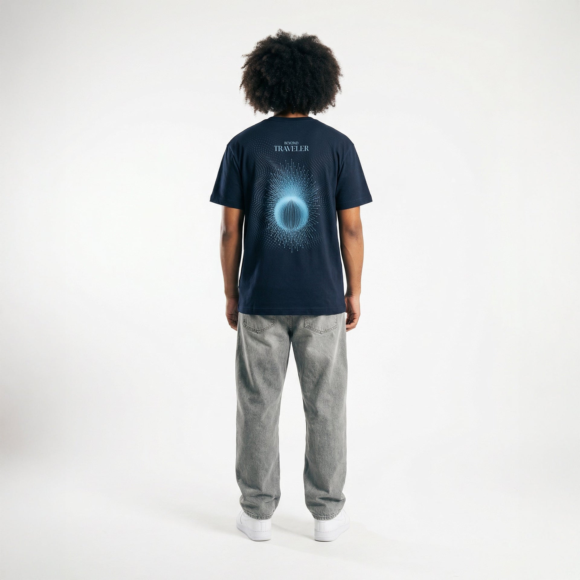 Back view of oversized navy organic t-shirt featuring geometric traveler artwork, worn by male model, The Ei8ht apparel.